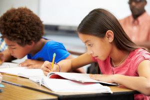 Pupils Studying At Desks In Classroom