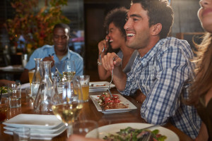 Group Of Friends Enjoying Meal In Restaurant