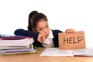 sweet little school girl bored under stress asking for help