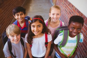 Smiling little school kids in school corridor